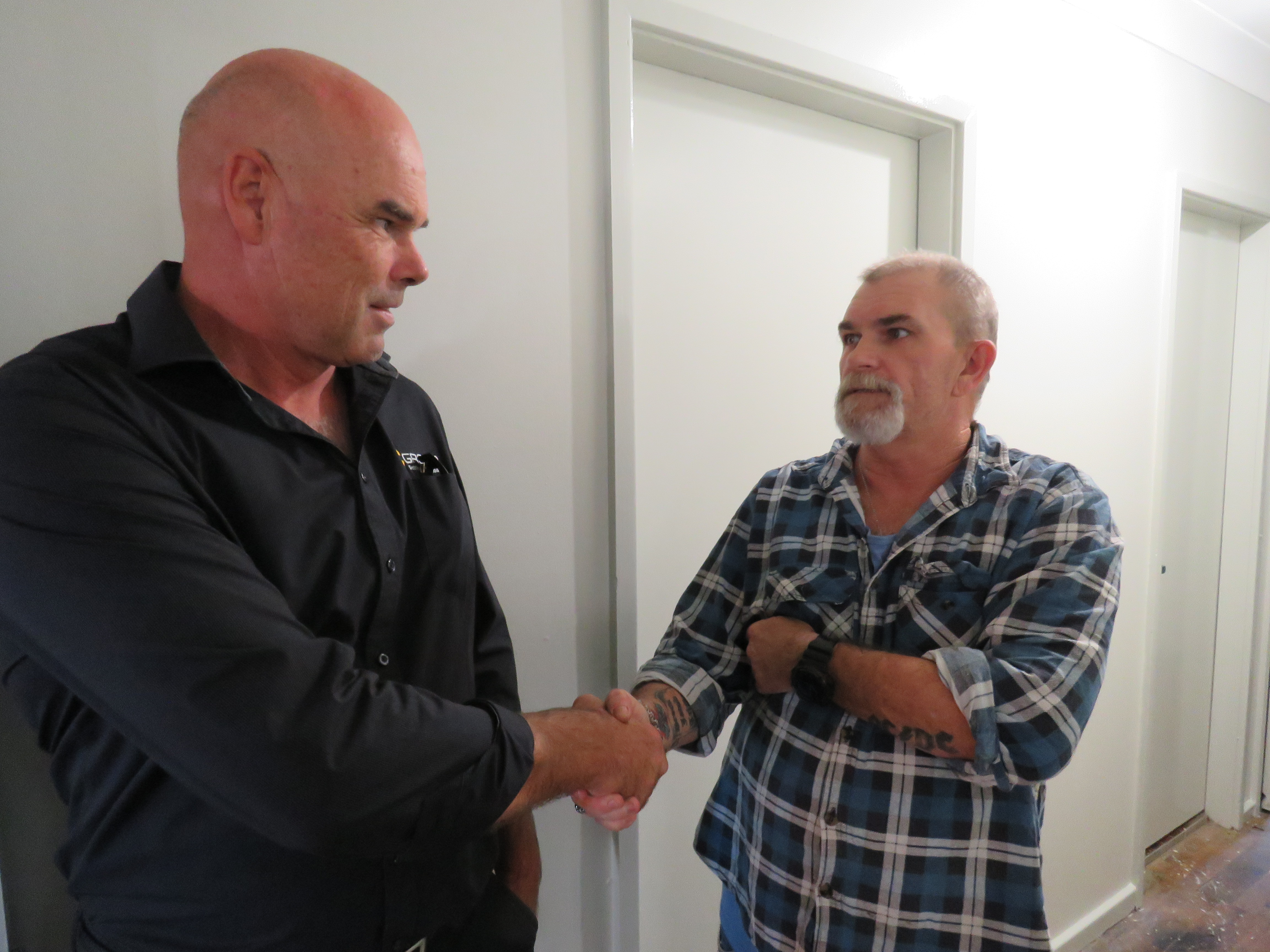 Hume customer Scott shaking hands with a tradesman.